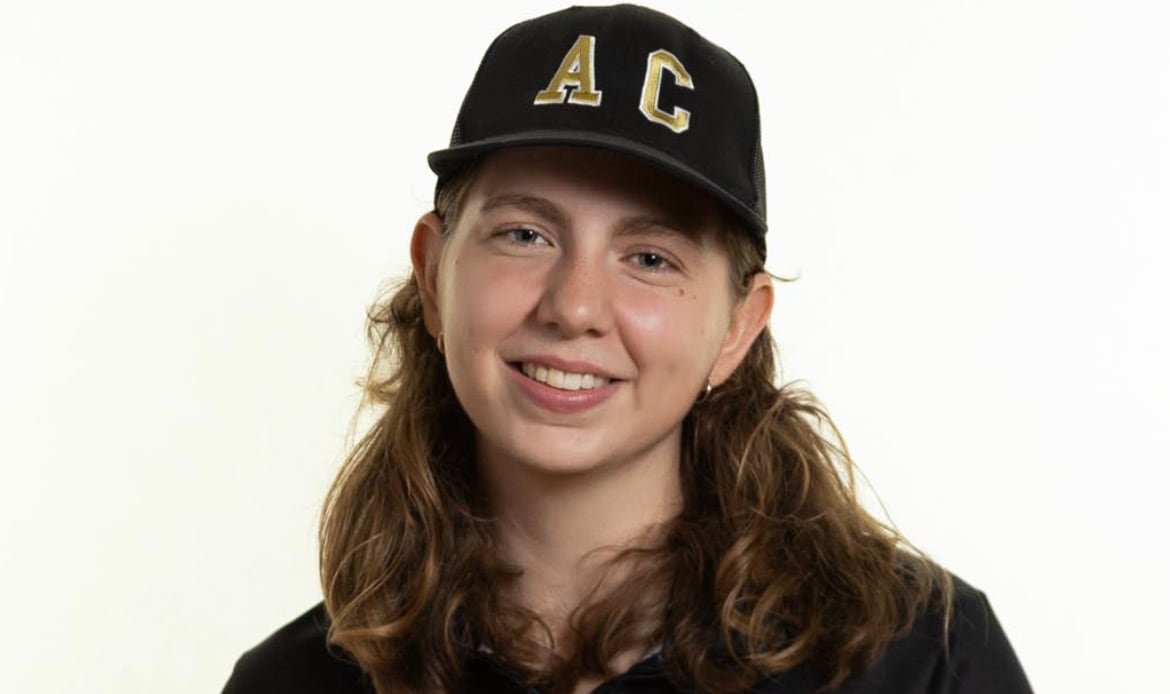default-248 A woman wears a ball cap that says AC (agricultural campus) and a sweater that says Dal AC.